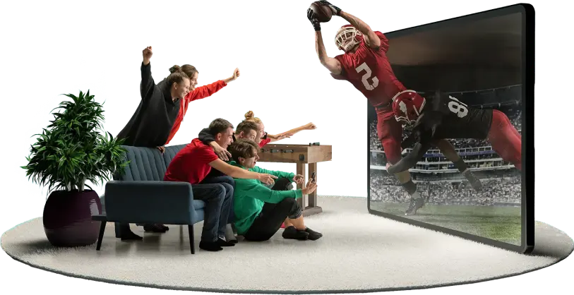 A group of people sitting on a couch watching a football game on a television.